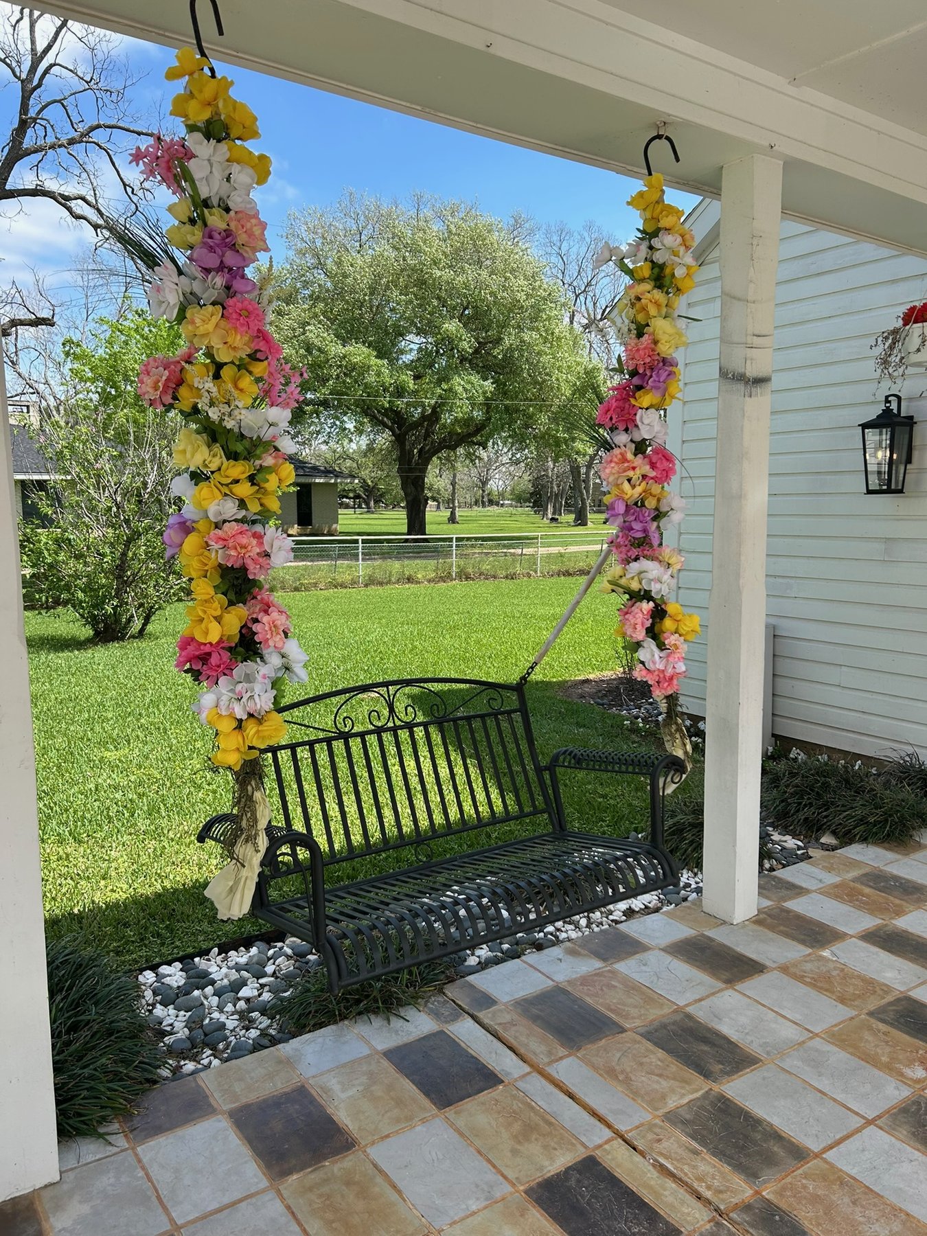 Porch swing wrapped in pink and yellow florals