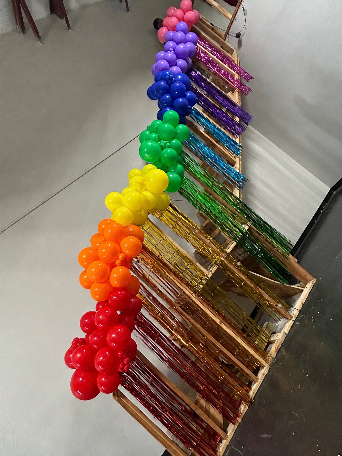 Rainbow balloon garland with matching fringe backdrop