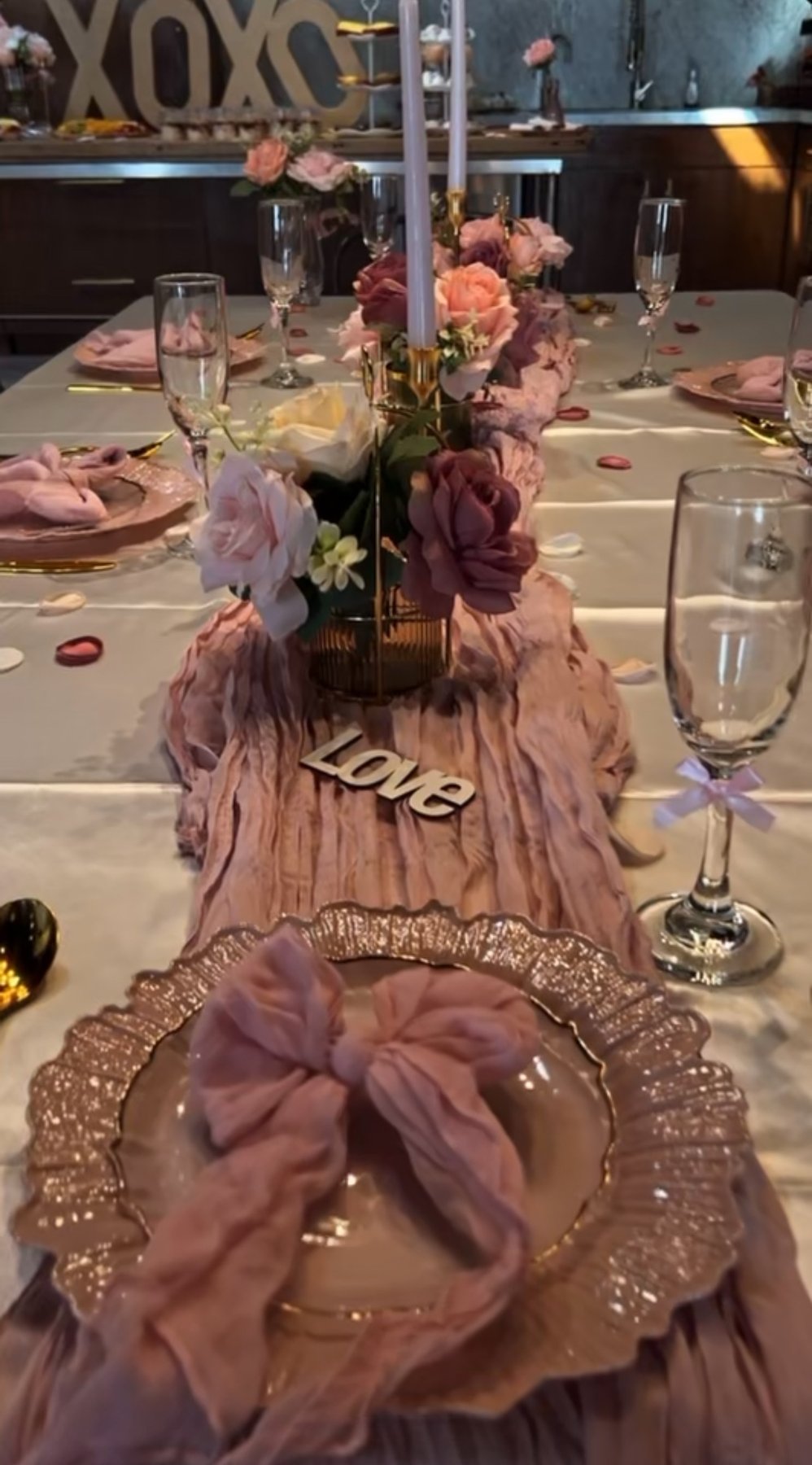 Blush tablescape with roses, taper candles and gold chargers