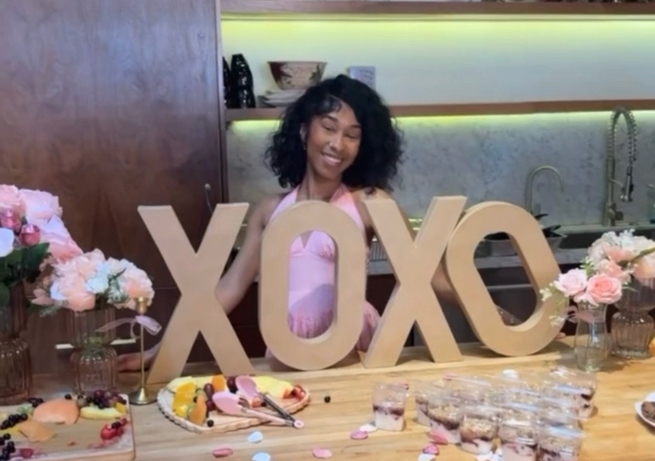 XOXO lettering with florals and a dessert spread at a Valentine themed party